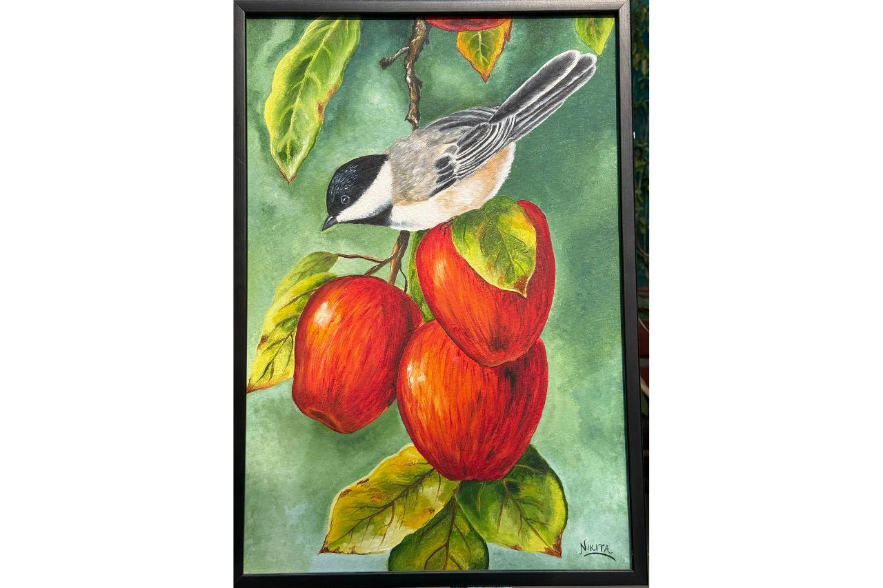 Bird sitting on an apple branch